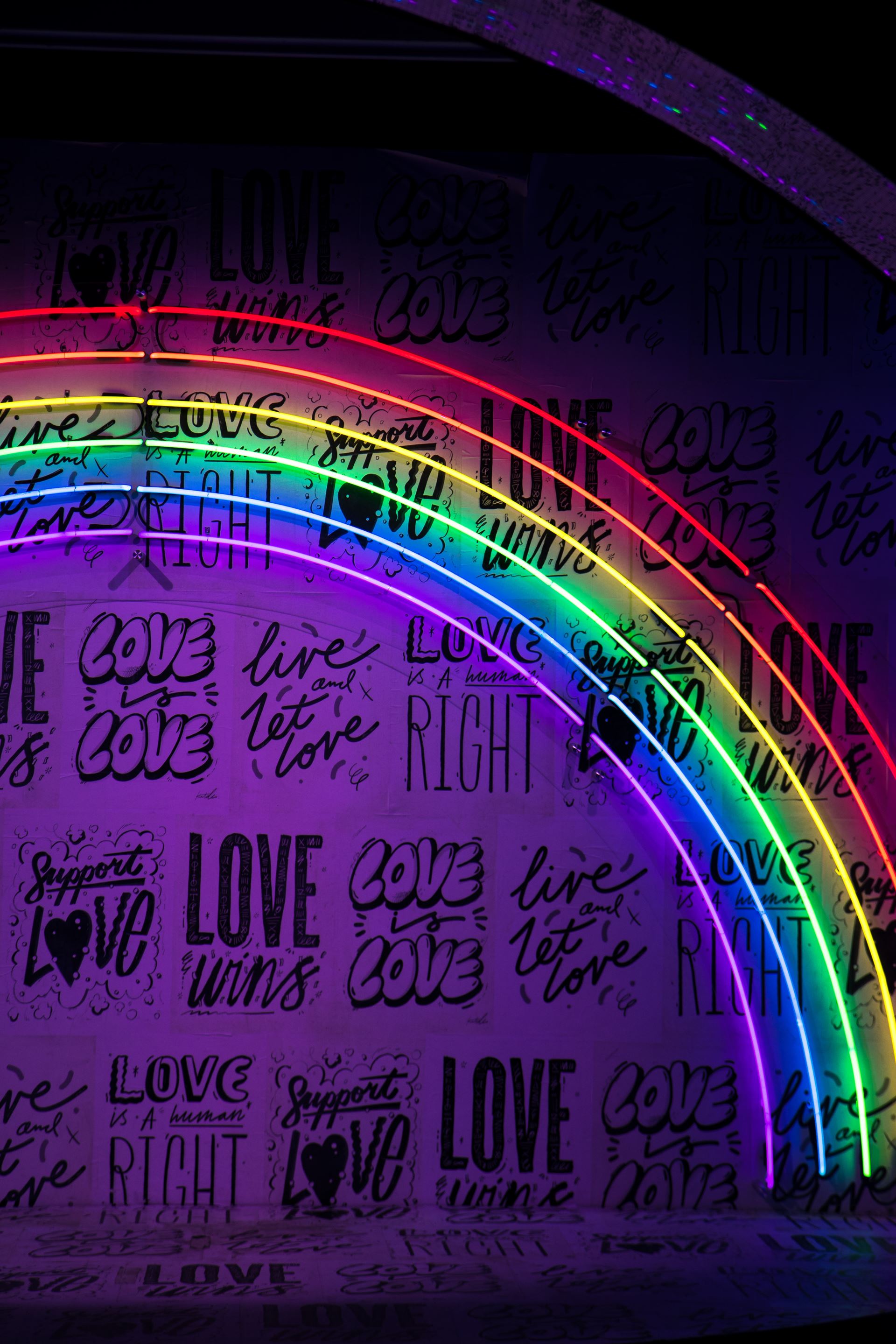 Love sign under a neon rainbow